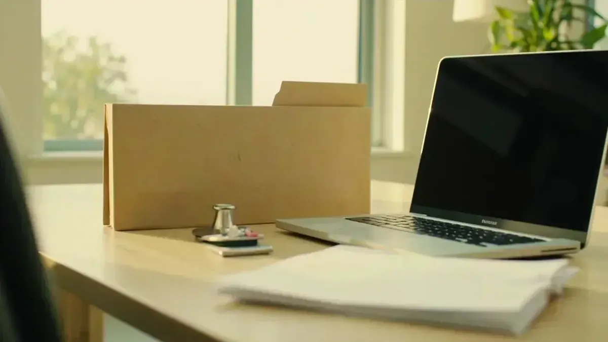 A sunlit home-office verification desk with a closed folder and unopened envelope